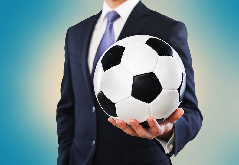 Business man holding ball