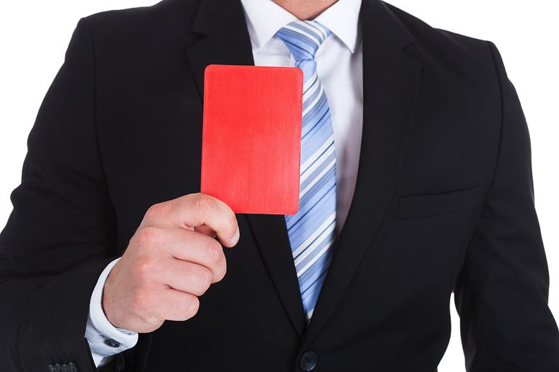 Man in suit holding a red card